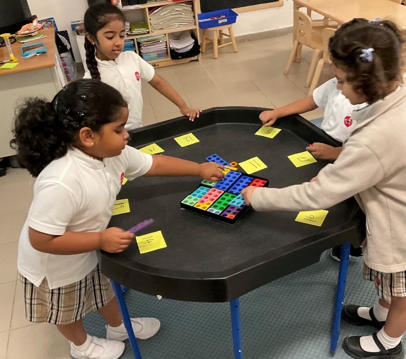 young learners playing blocks and numbers