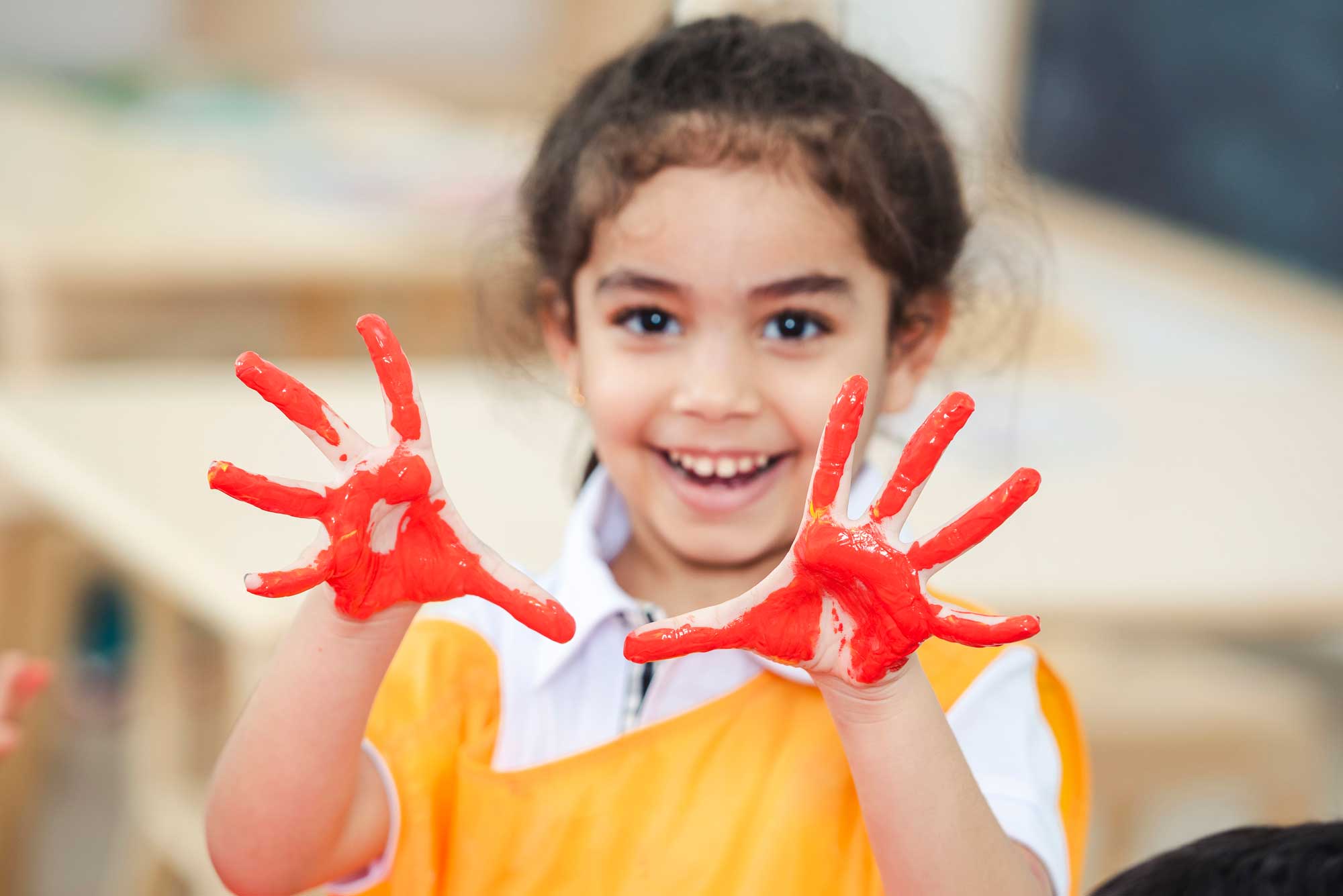 a young learn with hands painted