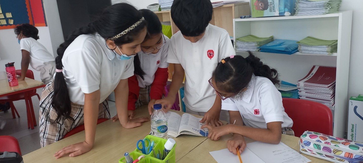 primary learners sharing a book